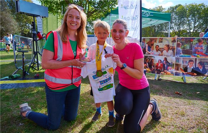 Volunteers with youngster medal